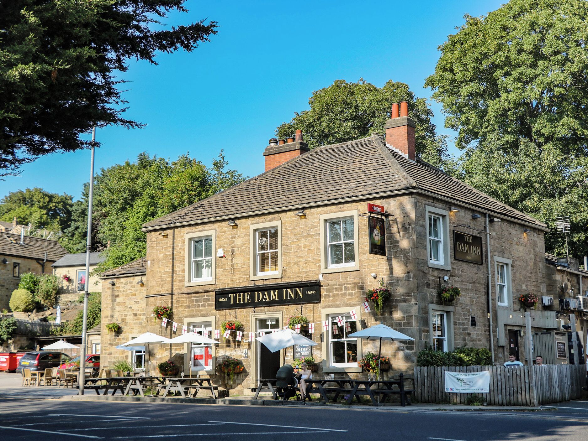 A traditional stone building with a sign reading 'The Dam Inn.'