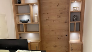 A wooden interior with a desk, shelves, and a door. - Hotel Wilms (Cologne)