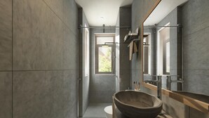 A modern bathroom with a large stone basin, a glass shower enclosure, and a wooden countertop. - Super apartment (Mérignac)
