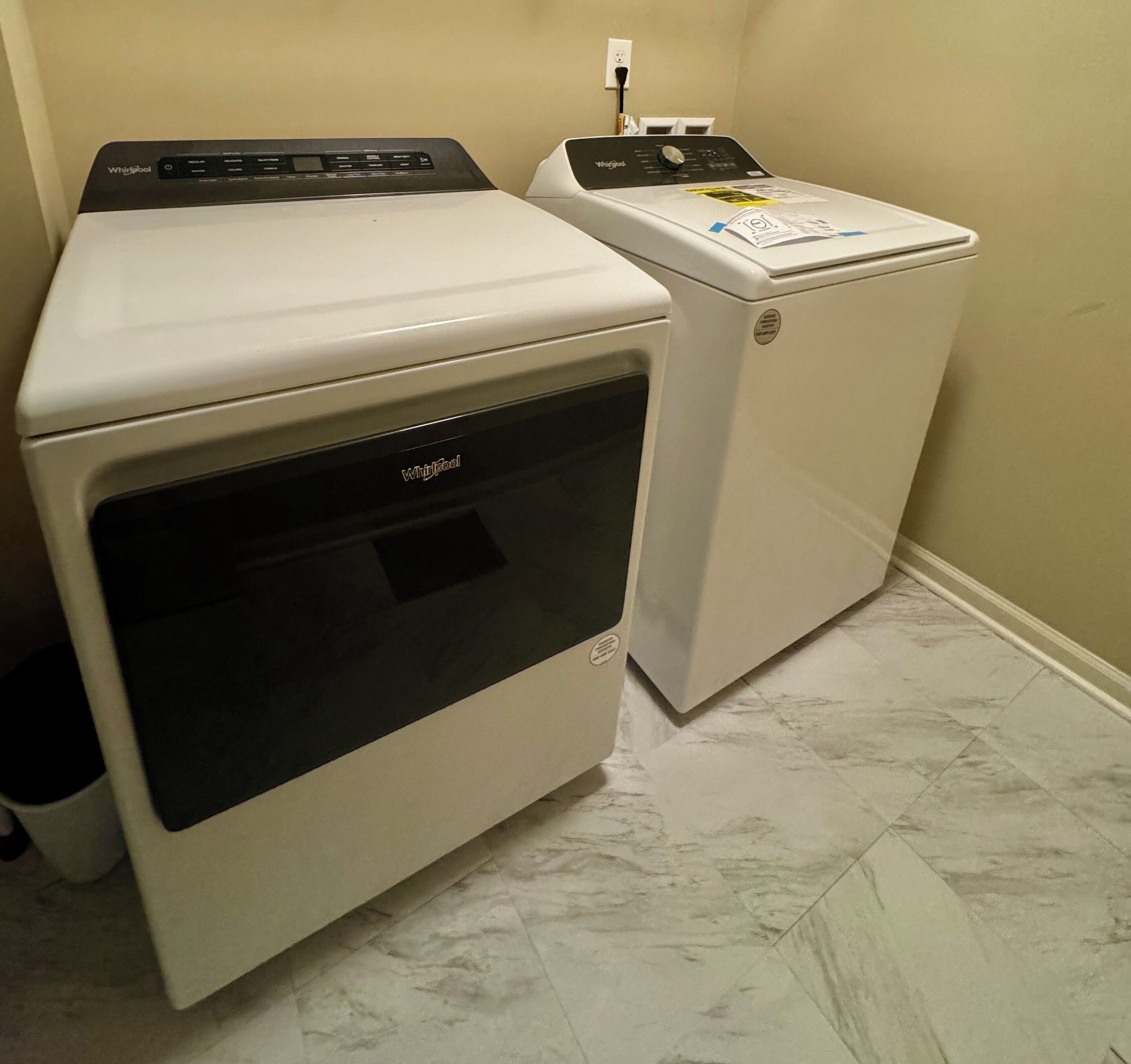 A laundry room with a front-loading washer and dryer.