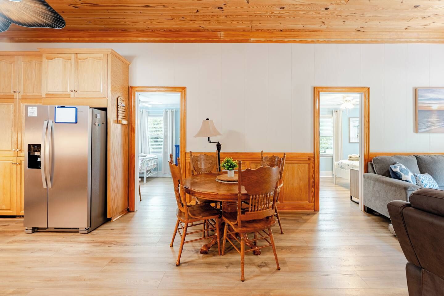 A modern kitchen with wooden cabinets and a stainless steel refrigerator.
