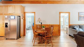 A modern kitchen with wooden cabinets and a stainless steel refrigerator.
