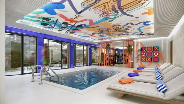 A modern indoor pool area with a glass wall, a lounge with a sofa, and a ceiling with colorful artwork. - Symone Poitiers  (Poitiers)