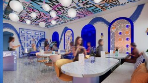A modern interior with round tables, comfortable seating, and a vibrant ceiling design. - Symone Poitiers  (Poitiers)