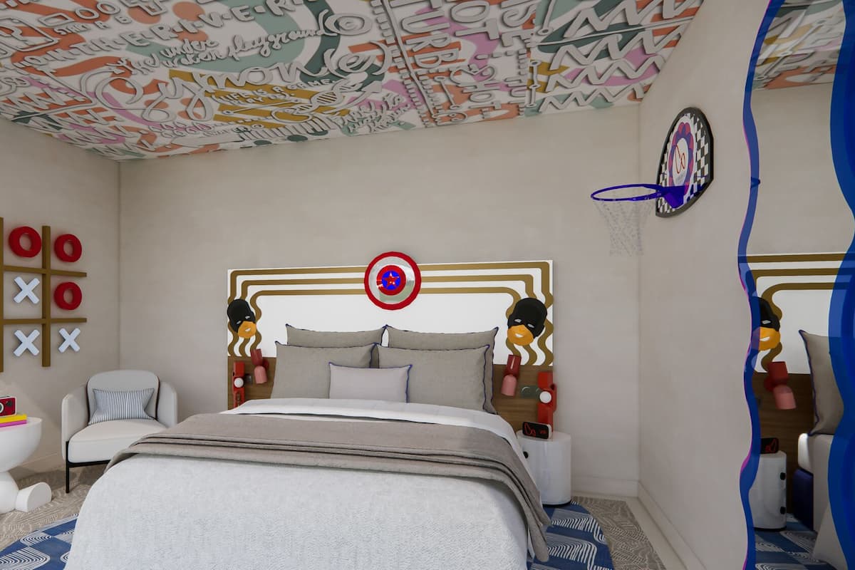 A bedroom with a bed, a headboard with a target design, a tic-tac-toe game, and a wall with abstract patterns.