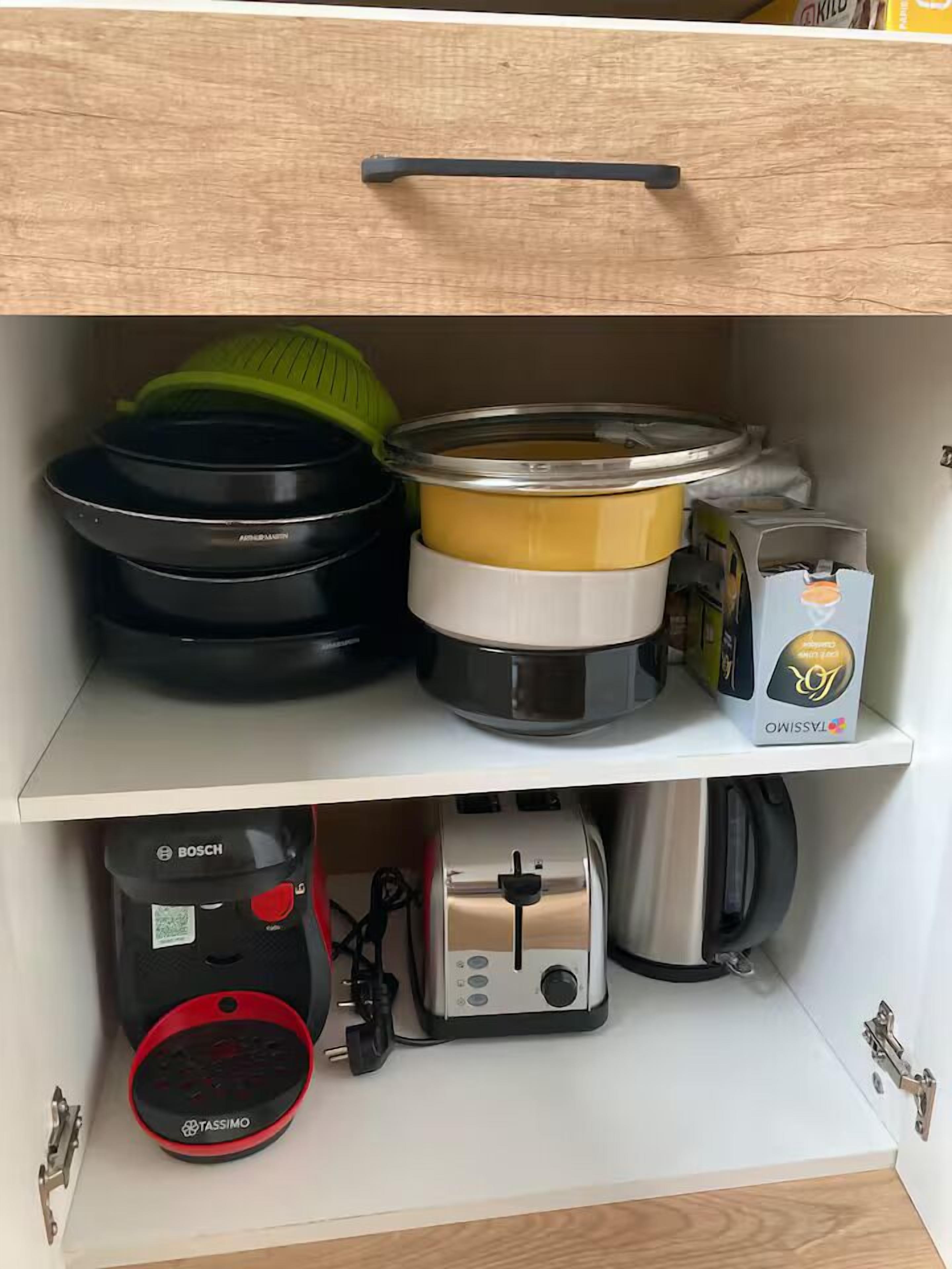 A kitchen with a Bosch coffee maker, a Tassimo coffee pod dispenser, and a toaster.