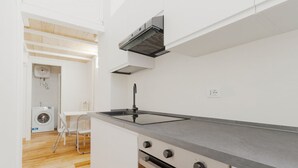 A compact kitchen with a built-in stove, a sink, and a ventilation hood. - GuestHost - Modern mezzanine studio apartment of 30 m2, ideal for two people, located on the raised ground floor of a typical Milanese building (stairs to access the apartment).The property is located a stone's throw from the M1 Lima stop in a strategi (Milan)