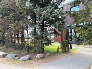 A building with a sign reading 'P.M. BOSTON' and a paved walkway.