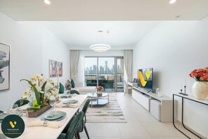 Luxury Apartment, Balcony, City View | Living area | 65-inch Smart TV with cable channels - Vogue | Downtown with Direct Access to Dubai Mall (Dubai)