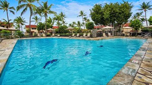 A swimming pool with lounge chairs and palm trees. - Oceanfront - Amazing Views - Completely Renovated - Vrkcv (Kailua-Kona)