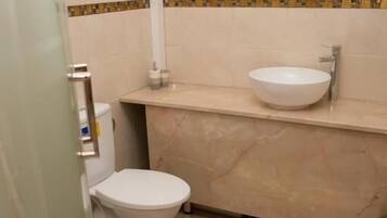 Family Double Room, City View | Bathroom | Combined shower/tub, towels, soap