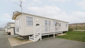 A white mobile home with a porch and a staircase. - 11, Beachfields (Rhyl)