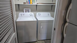 A laundry room with two front-loading washing machines and a dryer. - Shawnee Forest Retreat, Suite A, near Garden of the Gods, Southern IL (Harrisburg)