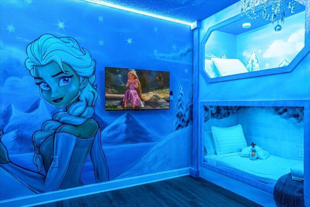 A room with a mural of a character, a bunk bed, and a framed picture on the wall.