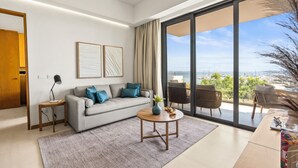 A modern living room with a sofa, coffee table, and a view of the ocean. - Alik (La Cruz de Huanacaxtle)