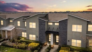A modern building with a symmetrical facade, multiple windows, and a central entrance. - Last Minute Disney Getaway! Private Pool & Themed Bedrooms. Book Now! #161419 (Orlando)