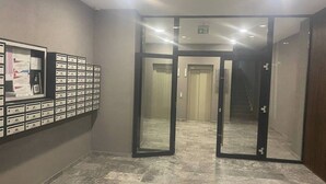 A hallway with a mail drop area and an elevator. - Platinium house (Sâncraiu de Mureș)