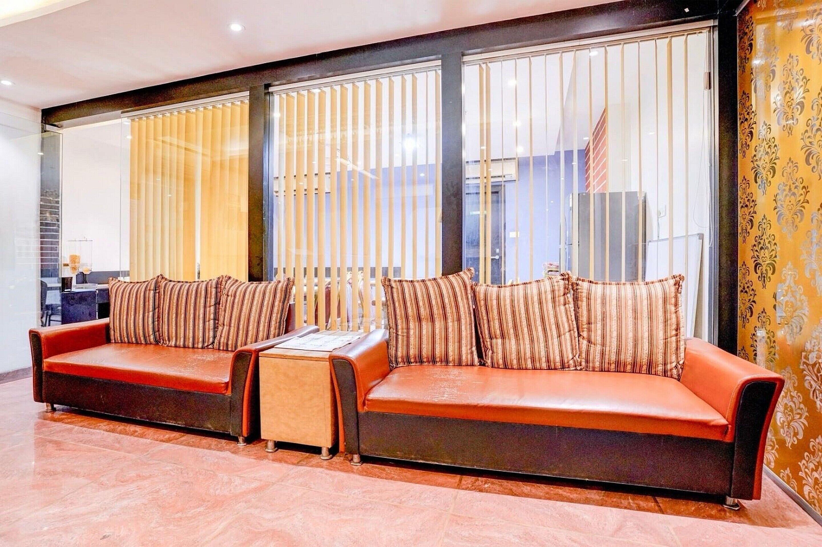 A modern living room with a sofa set, a small table, and a decorative wall.