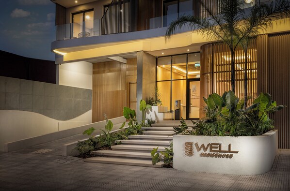 A modern building with a well sign, a staircase, and a reception area.