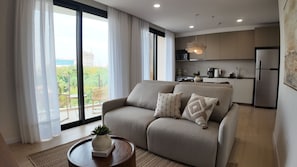 Deluxe Apartment | Living area | 45-inch Smart TV with cable channels - Well Residences - By AVA Rentals (Asunción)