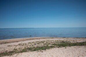A beach with clear water and a sandy shore.
