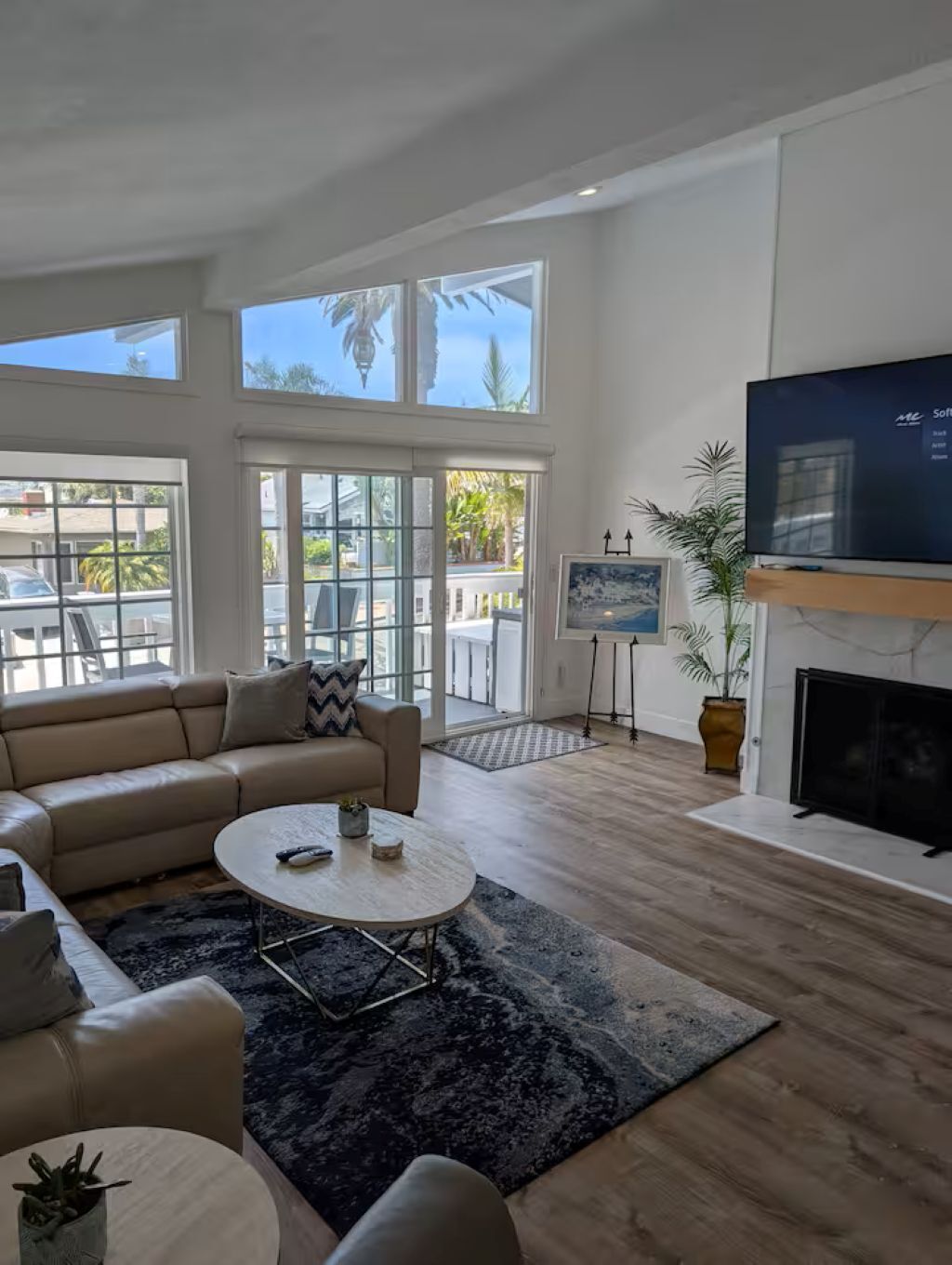 A spacious living room with a large sofa, a coffee table, and a fireplace.