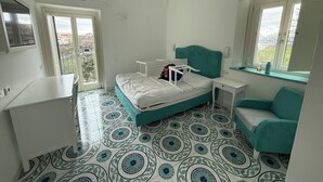 A room with a bed, a desk, a chair, and a window with a view. - Large apartment Always strength Naples (Napoli)