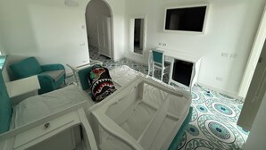 A room with a bed, a desk, a chair, a TV, and a patterned floor. - Large apartment Always strength Naples (Napoli)