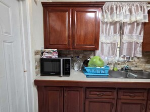 Fridge, microwave, oven, stovetop - Adorable 3-bedroom apartment with AC in Elms Hall Roseau. (Elms Hall, Roseau)