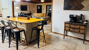 A modern kitchen with a central island, black chairs, and pendant lighting. - This special place is close to everything, making it easy to plan your visit. (Quitman)
