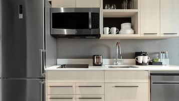A modern kitchen with stainless steel appliances, a microwave, a toaster, and a coffee maker.
