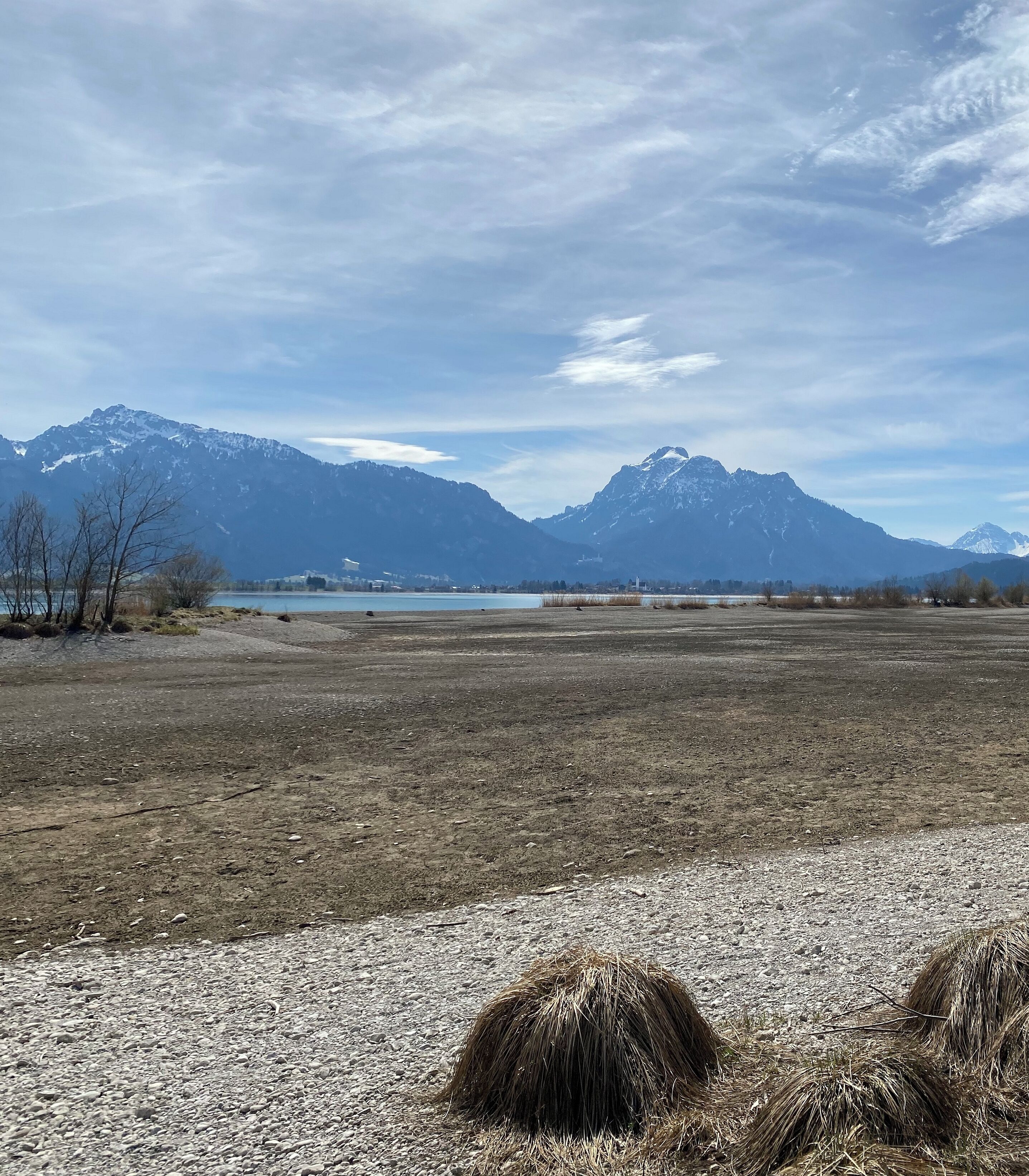 A wide-open field with mountains in the background and a clear sky.