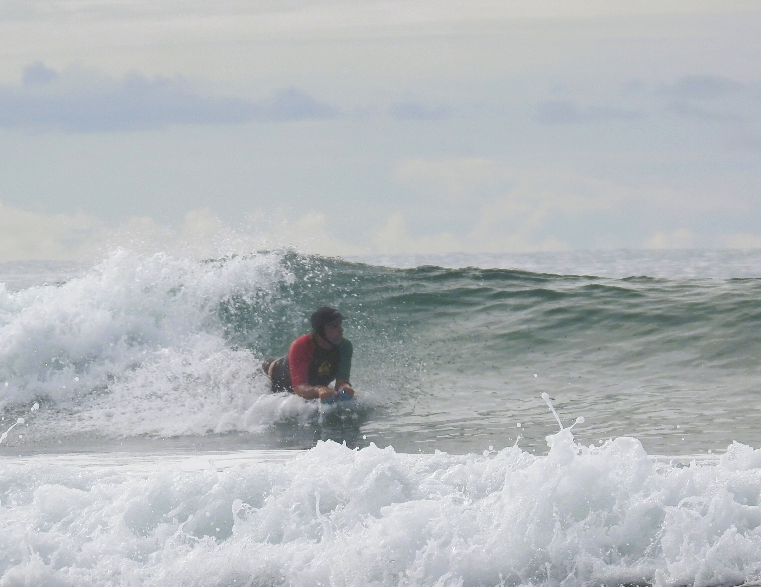 A person surfing a wave in the ocean.