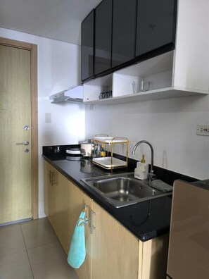 Fridge, microwave, stovetop, dishwasher - Urban Oasis at A & K Vibes City-View Condo (Quezon City)