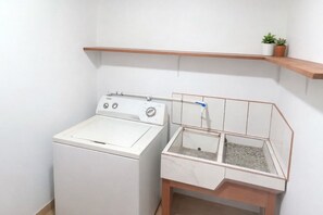 A compact laundry area with a washing machine and a drying rack. - Hidden Retreat Near Chirripó - Healing, Deep Rest, Inspiration & Mountain Magic (San José Province, Rivas, Costa Rica)