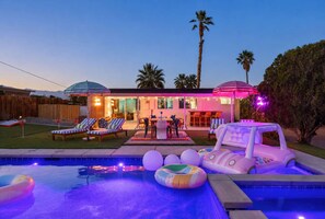 A house with a swimming pool, outdoor seating, and a tiki bar. - Peaks & Palms Oasis - Heated Pool - Games (Palm Springs)