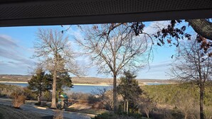A view of a lakeside property with a gazebo, a dock, and a stone pathway leading to the water. - Open Lakeview Cottage #5 at Teal Point Resort on Lake Norfork (Mountain Home)