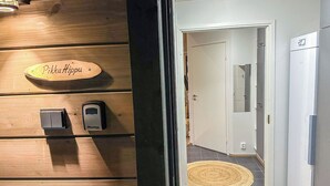 A wooden wall with a sign reading "PikkuHippu" and two MasterKey devices. - Pikkuhippu by Interhome (Pelkosenniemi)