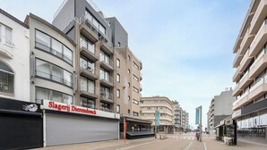 A modern building with multiple balconies and a storefront named "Slagerij Dierendonk." - Walter Vilain 0301 + G* (Sint Idesbald)