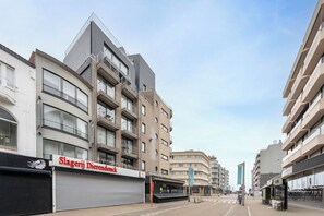 A modern building with multiple balconies and a storefront named "Slagerij Dierendonk." - Walter Vilain 0301 + G* (Sint Idesbald)