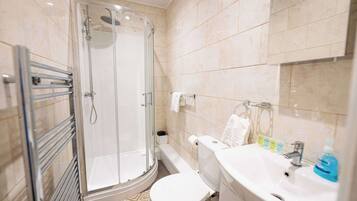 Shower, hair dryer, towels, shampoo