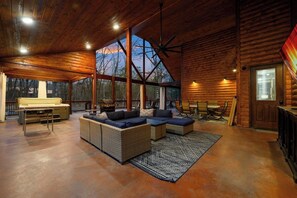 TV, fireplace, table football, books - Mystic River Retreat · Spacious Escape: Hot Tub, Game Room, EV Charger (Broken Bow)
