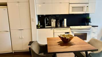 Classic Condo, City View | Private kitchen | Fridge, microwave, cleaning supplies, paper towels