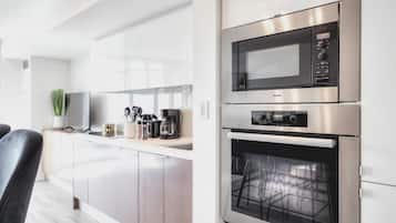 Exclusive Condo, Lake View | Private kitchen | Fridge, microwave, cleaning supplies, paper towels