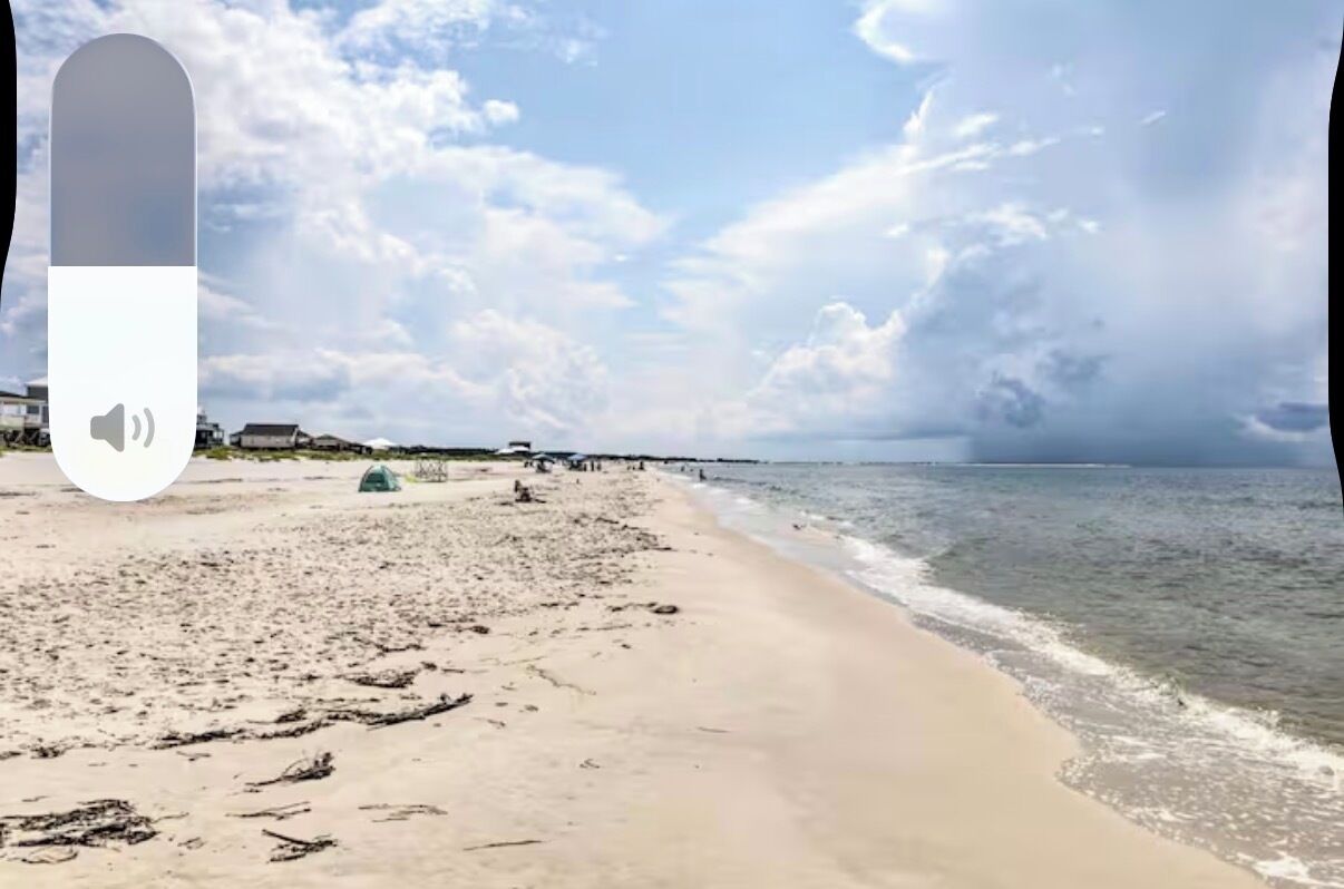 A beach with a clear sky and calm sea.
