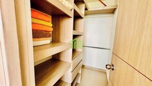 A wooden closet with multiple shelves and a door. - SUMMER APARTMENT IN SANTA FE DE ANTIOQUIA (Santa Fé de Antioquia)