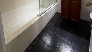 A bathroom with a glass-enclosed shower, a wooden vanity, and a mirror above the sink. - Hotel Casa Recoleta (Buenos Aires)