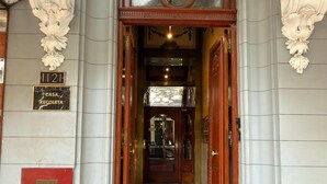 A grand entrance with a wooden door, a marble plaque reading "Casa Recoleta," and a number "1121" above it. - Hotel Casa Recoleta (Buenos Aires)