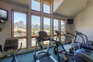 A gym with treadmills, stationary bikes, and a rowing machine, large windows with a mountain view. - Condo w Mountain Views, Jetted Tub and 2 Balconies (Durango)