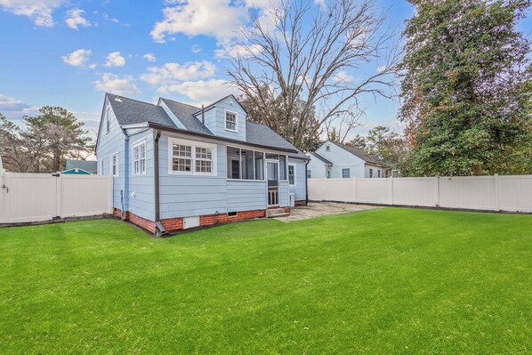 A single-story house with a front porch and a small front yard.